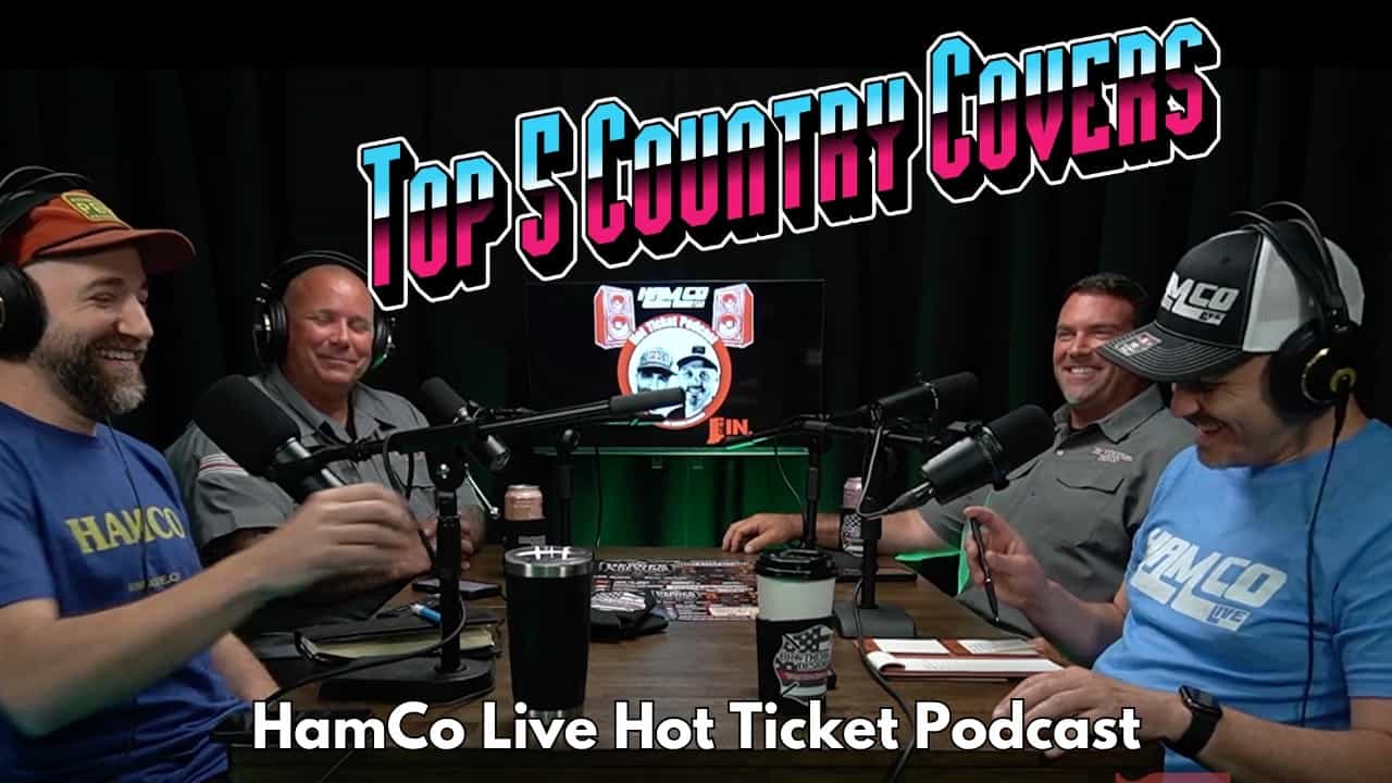 Four men around the HamCo Live Hot Ticket podcast table wearing headphones and speaking into microphones, two in HamCo Live shirts and two in gray Fishers firefighter uniforms, with a 'Top 5 Country Covers' title overlay