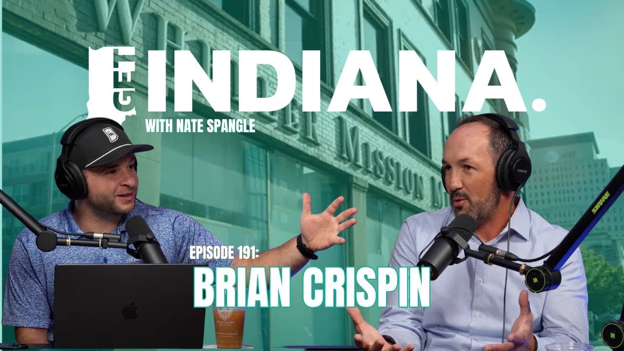 Two men discuss life-changing experiences in front of the historic Wheeler Mission building in Indiana.