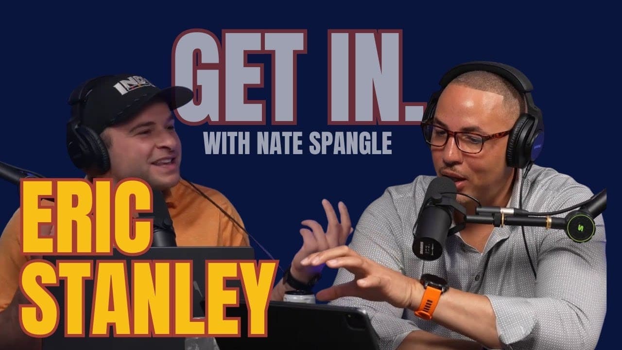 Two men engaged in a podcast discussion, microphones in front, with a blue background featuring "Get In." and names.