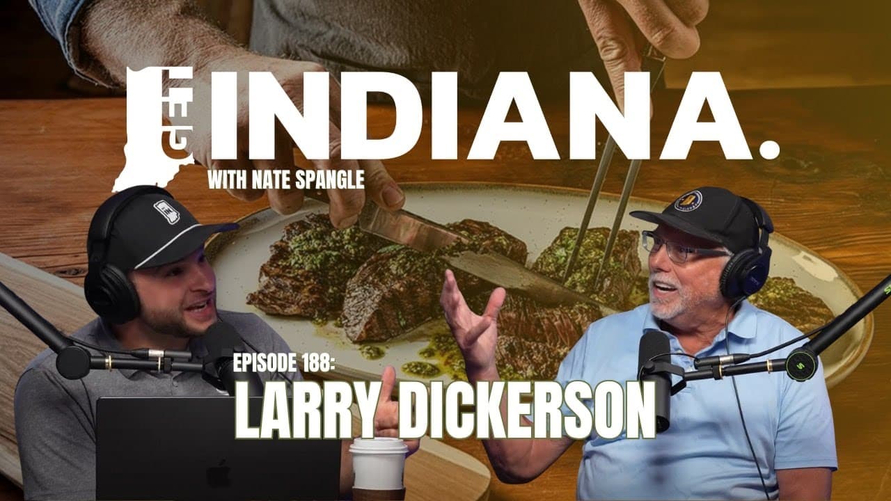 Two hosts discuss gourmet steak on a wooden table, highlighting Indiana's culinary scene.